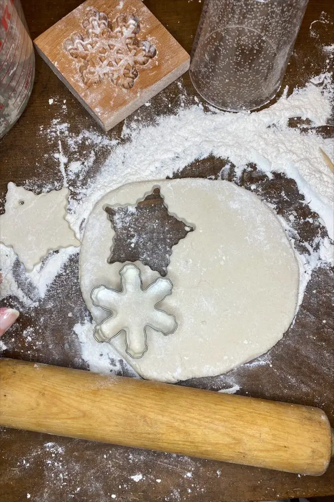 salt dough rolled out and cut with star and snowflake shaped cookie cutters
